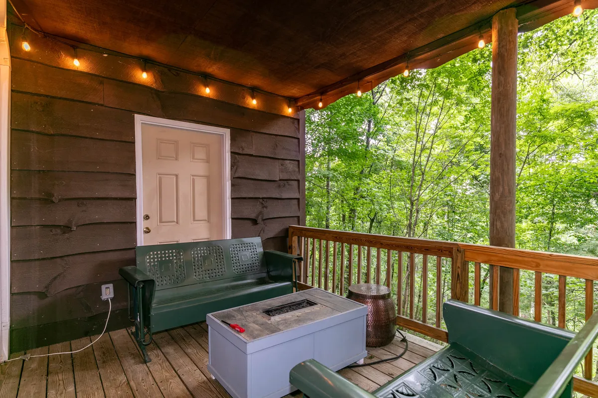 A cozy outdoor seating area with a fire pit, surrounded by greenery. The scene is set for casual gatherings or quiet moments, with the backdrop of nature suggesting opportunities for both human and pet relaxation after a day on the trails.
